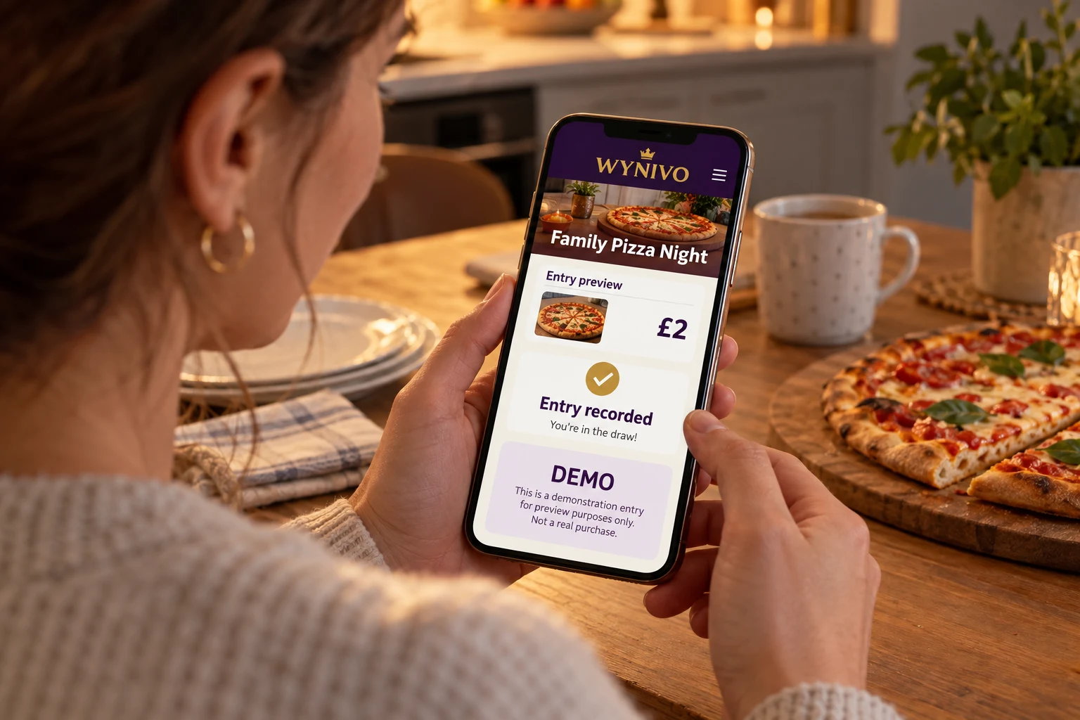 AI-created staged photo: an adult at a kitchen table holds a phone showing a demo WYNIVO Family Pizza Night entry confirmation. Not an actual entrant or entry.